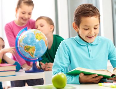 happy boy reading book close apple 1 – Bilingual Immersion: A Pathway to Multilingual Proficiency – The Digital Boy